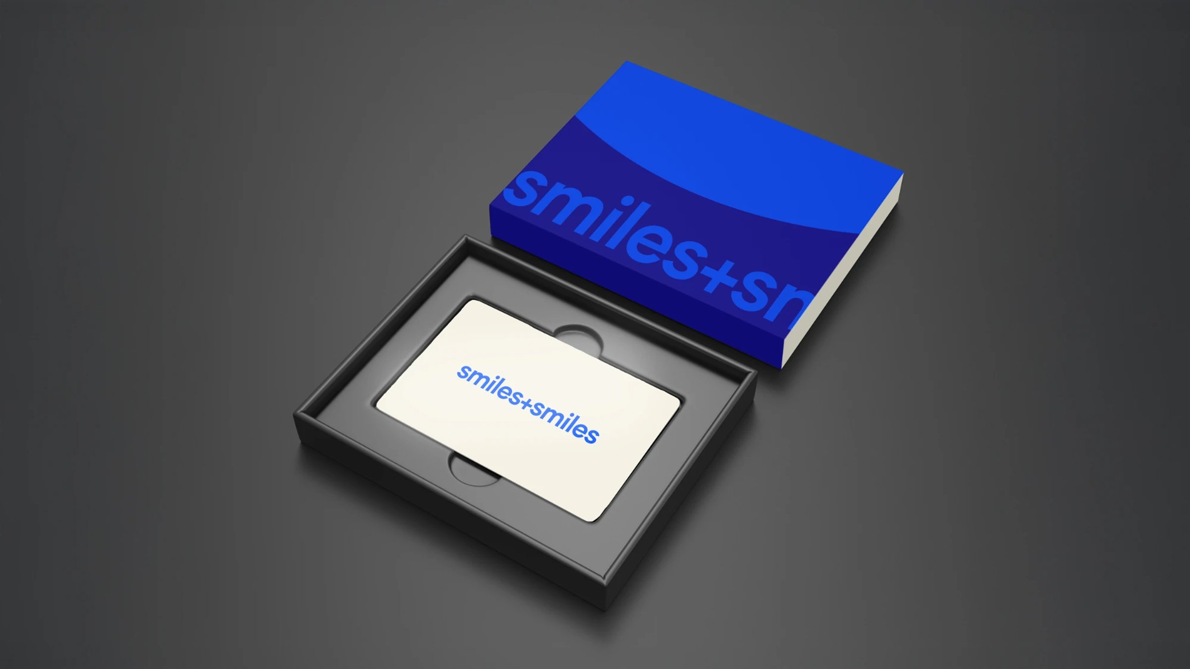 A Smiles+Smiles gift card displayed open in its presentation box