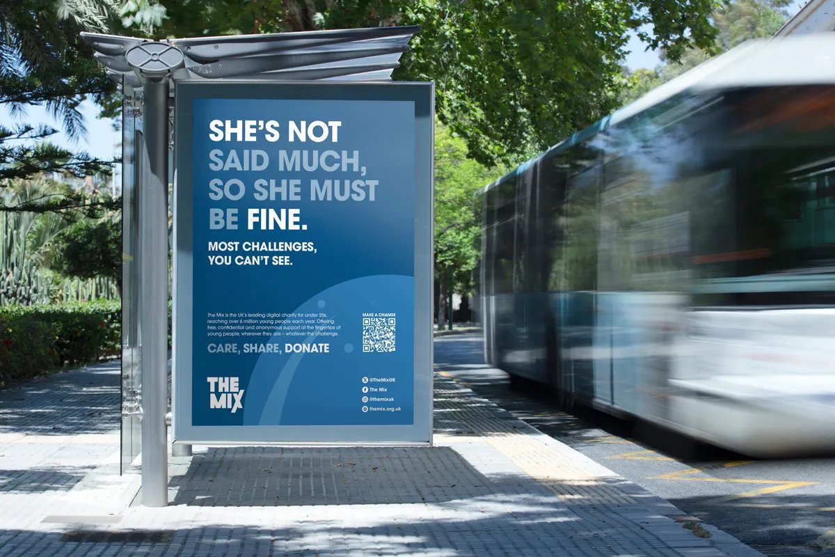 The Mix bus stop advertisement in blue that reads "SHE'S NOT SAID MUCH, SO SHE MUST BE FINE. Most challenges you can't see."