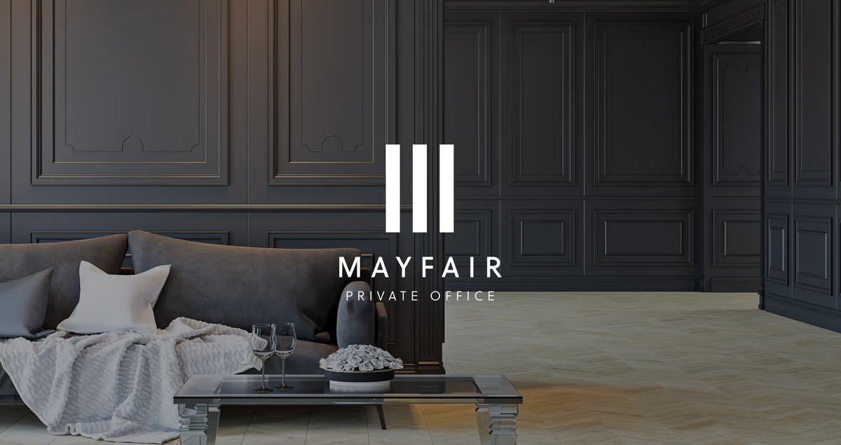 Mayfair Private Office logo overlaid on a dark panelled living room with a grey sofa and coffee table