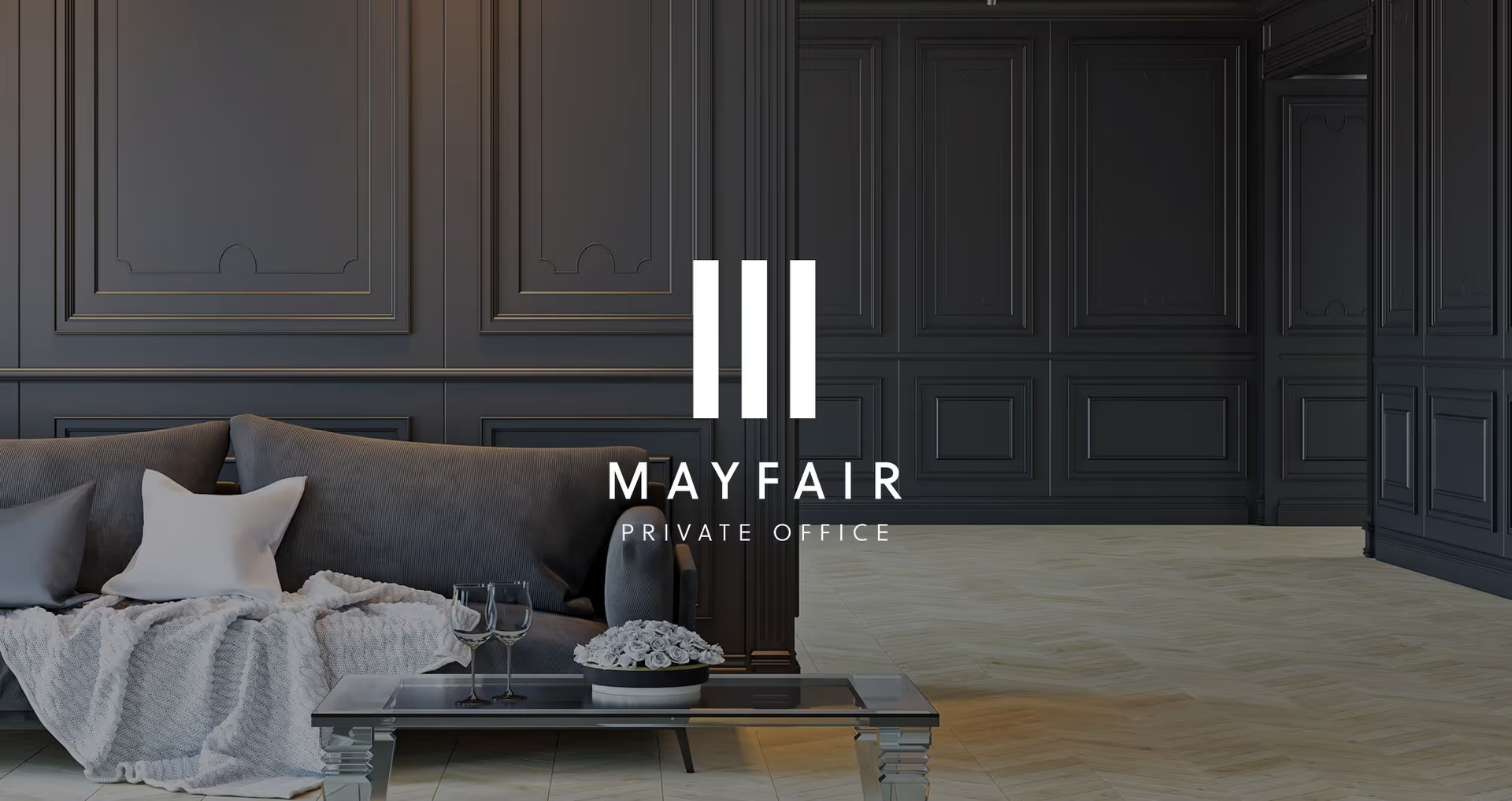 Mayfair Private Office logo overlaid on a dark panelled living room with a grey sofa and coffee table