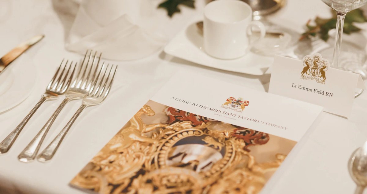 Merchant Taylors table brochure on a fine dining table.