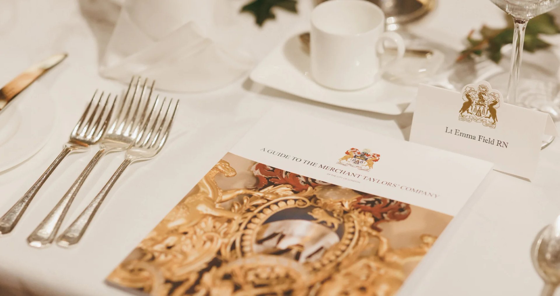 Merchant Taylors table brochure on a fine dining table.