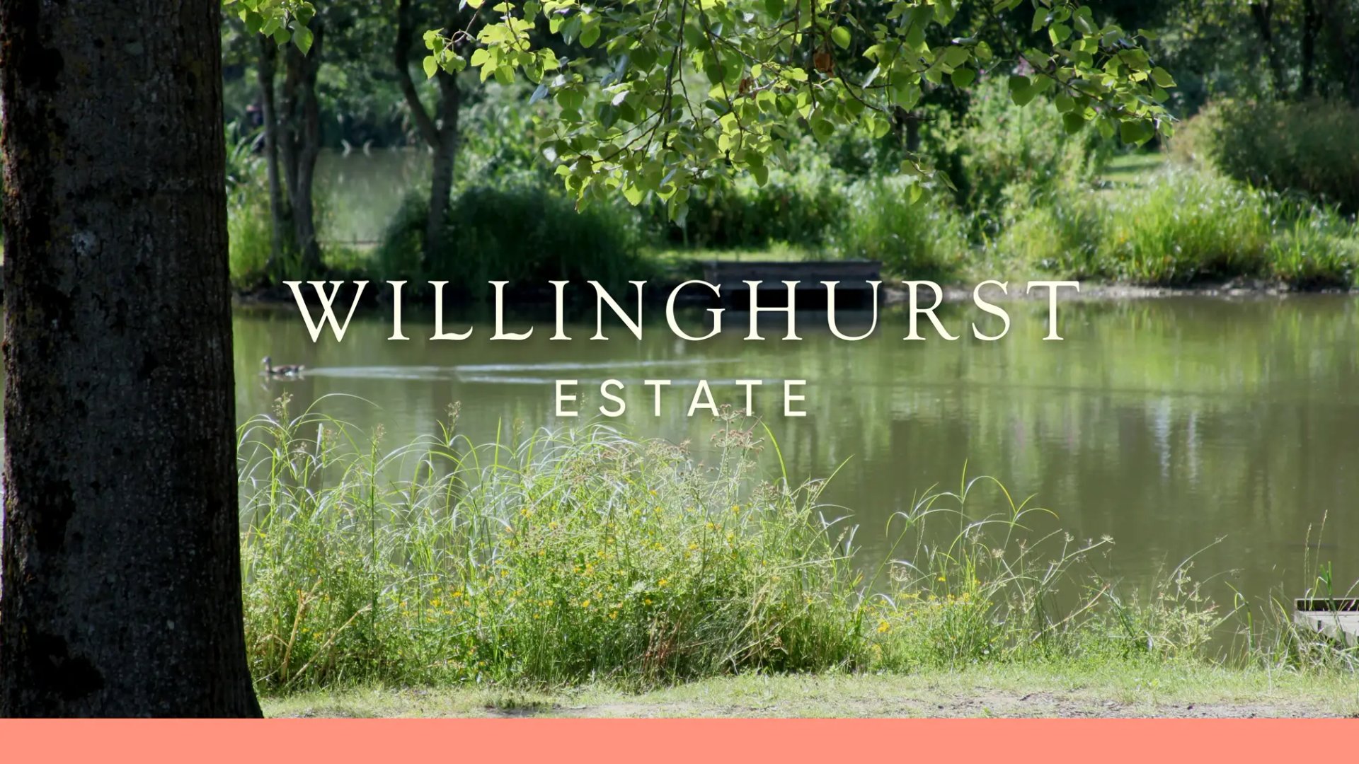 A tranquil a fishing lake with Willinghurst Estate written