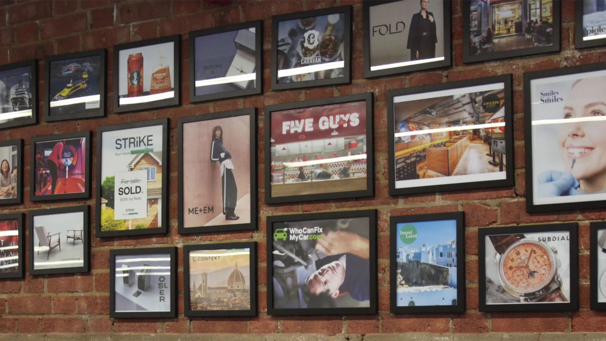 A gallery of images on the wall at Freston Ventures
