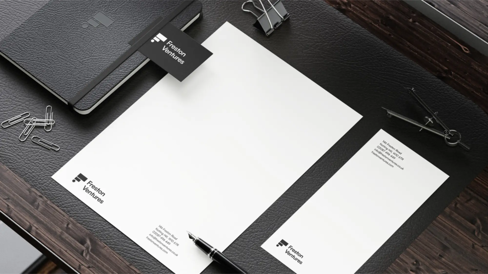 A letterhead and other stationery on a desk in the Freston Ventures branding