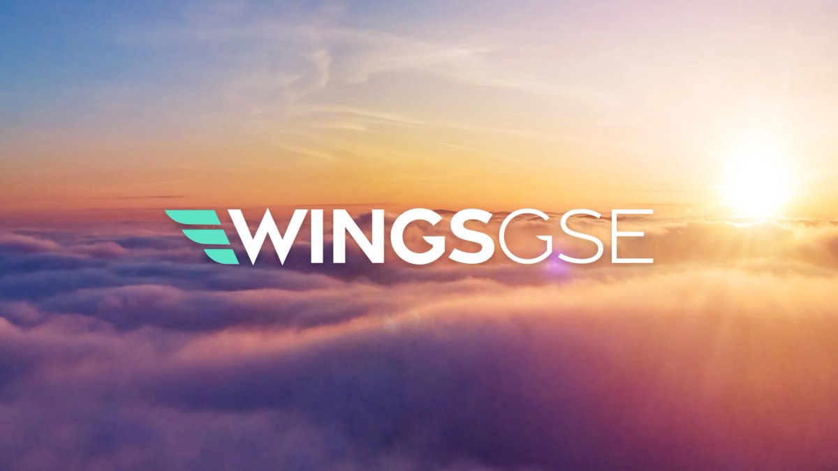 Wings GSE written over an image of clouds at sunset