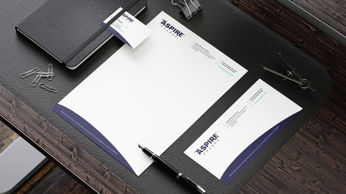 Mockups of Aspire Pharma stationery on a desk