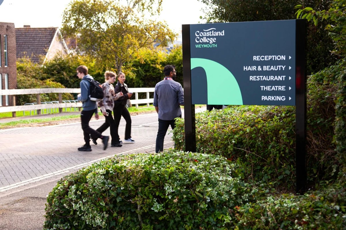 An outdoor wayfinding sign for Coastland College