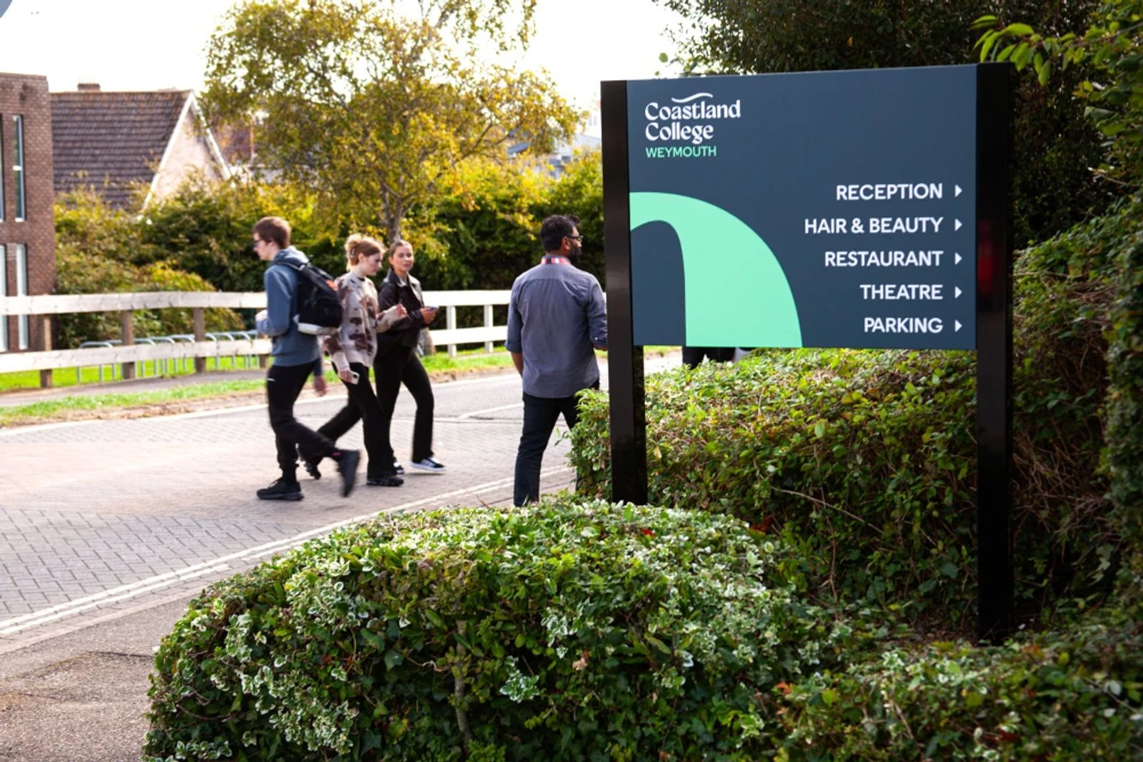 An outdoor wayfinding sign for Coastland College