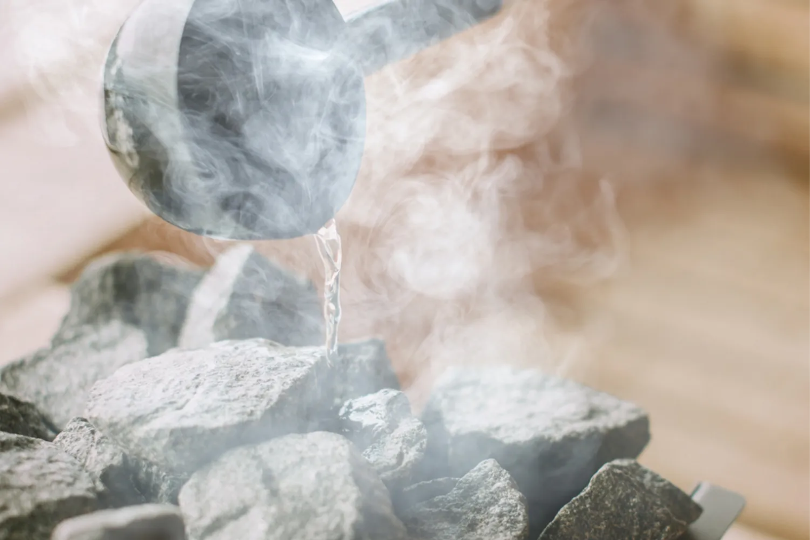 Water poured over hot sauna stones, creating rising steam