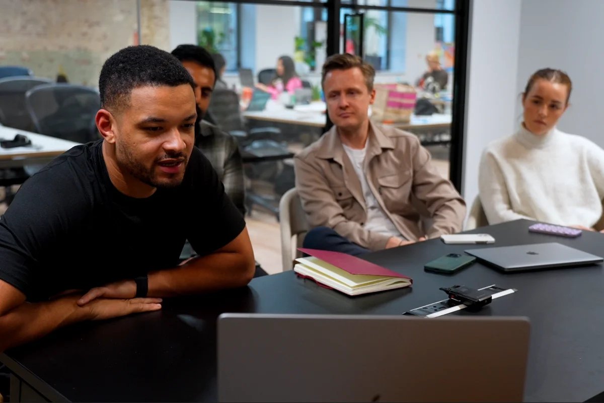 Steven Bartlett and his team on a call, sat in front of a laptop