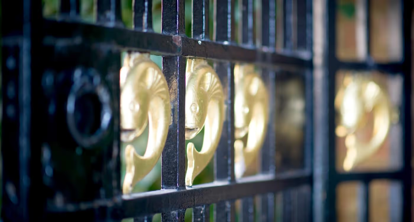 Gilded fish on a gate