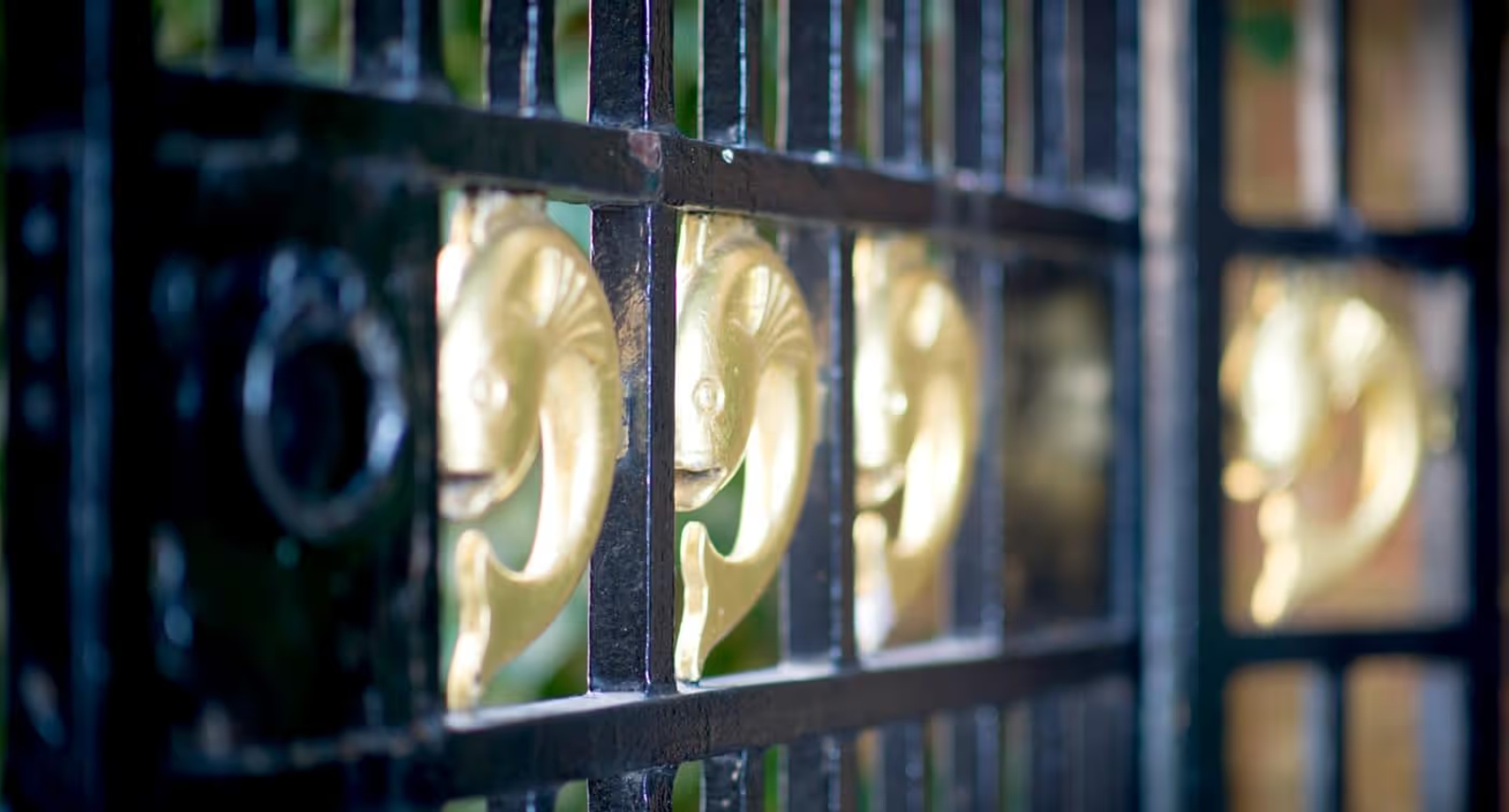 Gilded fish on a gate