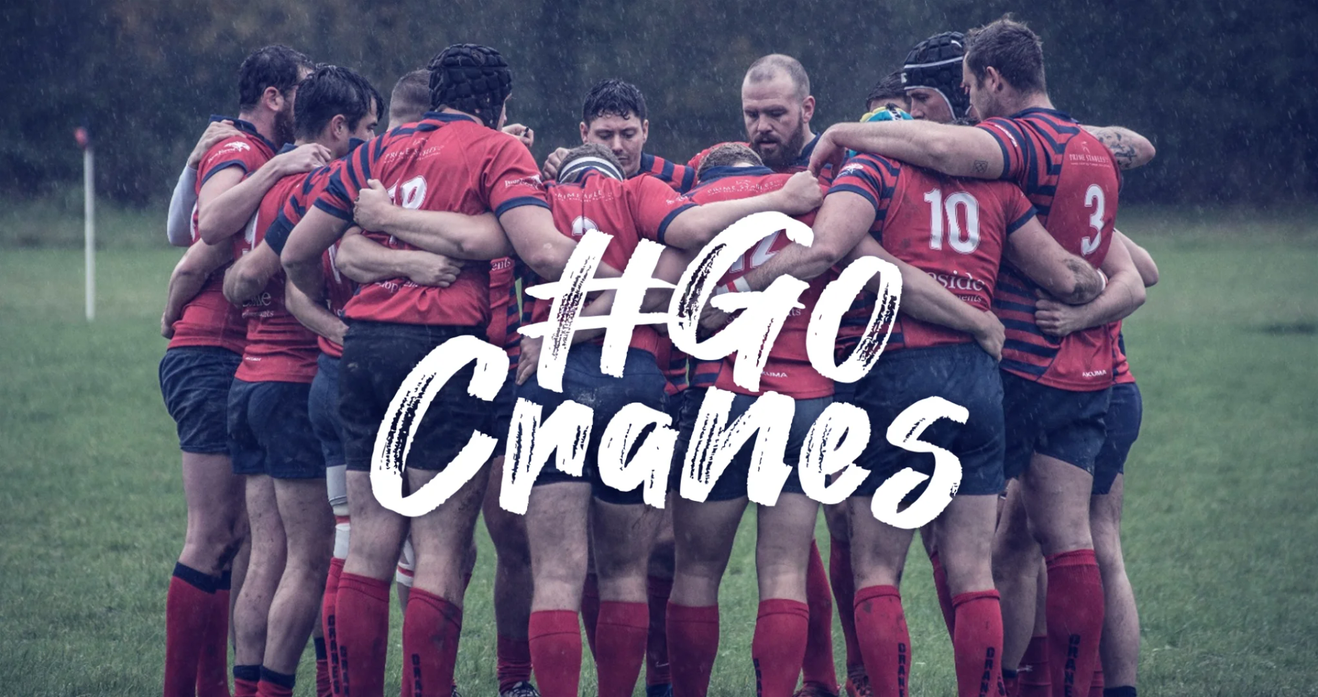 Cranleigh RFC players huddled together on the pitch in the rain, with '#GoCranes' text overlay