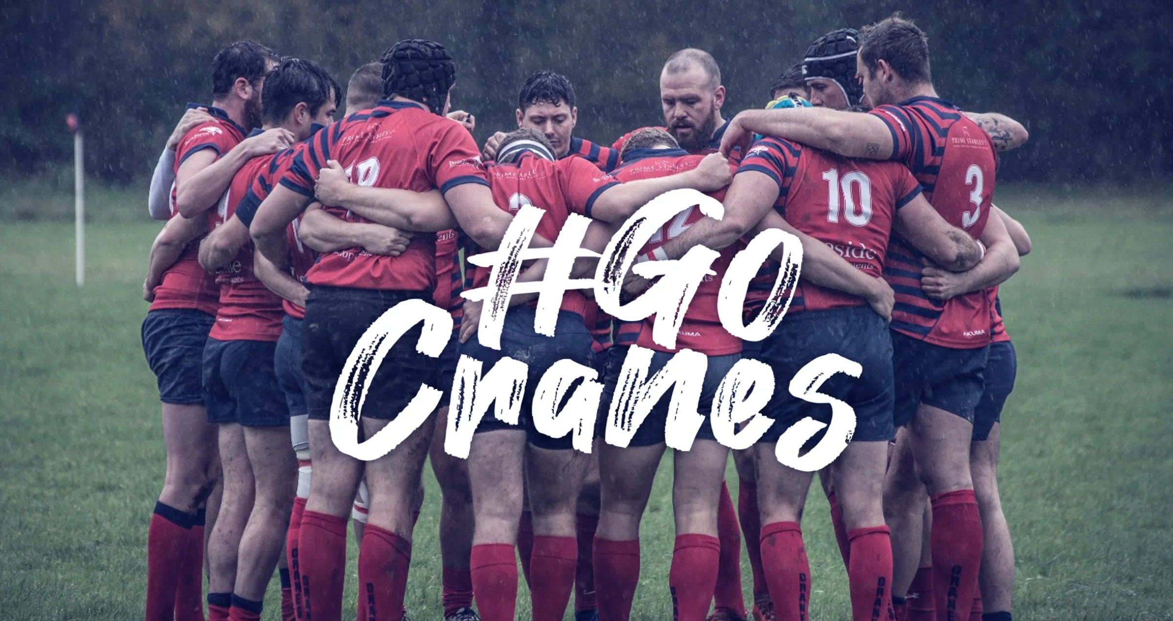 Cranleigh RFC players huddled together on the pitch in the rain, with '#GoCranes' text overlay