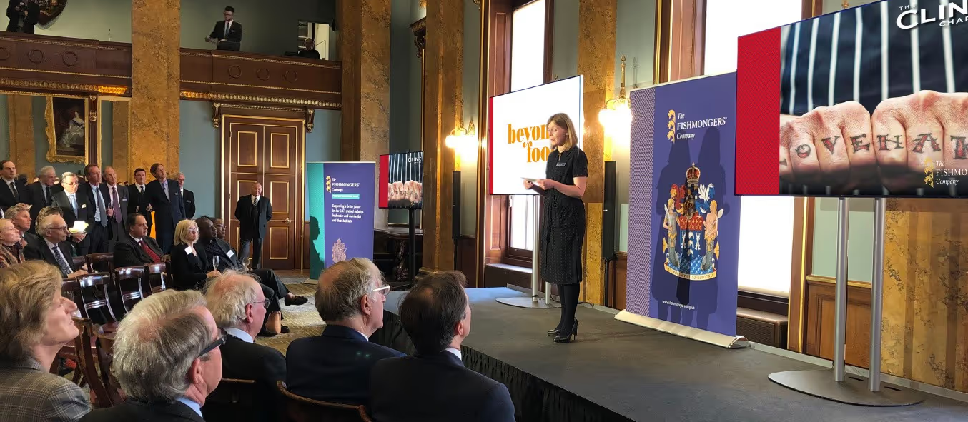 A woman on stage at the Fishmongers' hall giving a speech
