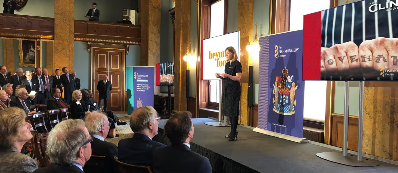 A woman on stage at the Fishmongers' hall giving a speech