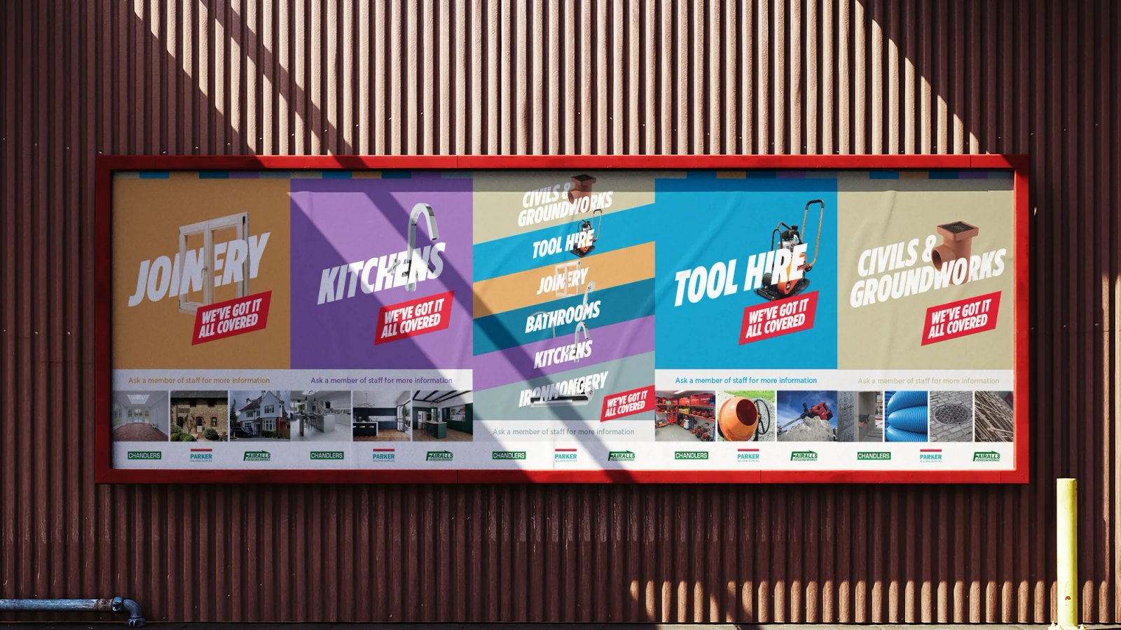A large outdoor billboard on a corrugated metal wall showing category panels for Joinery, Kitchens, Civils & Groundworks and Tool Hire