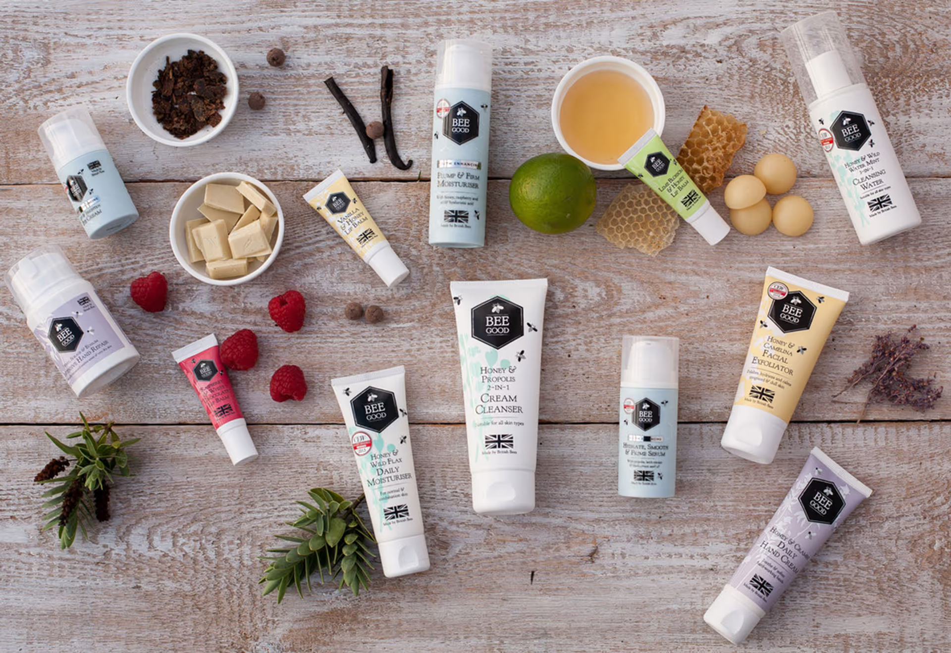 A selection of products from Bee Good Cosmetics displayed on a wooden table