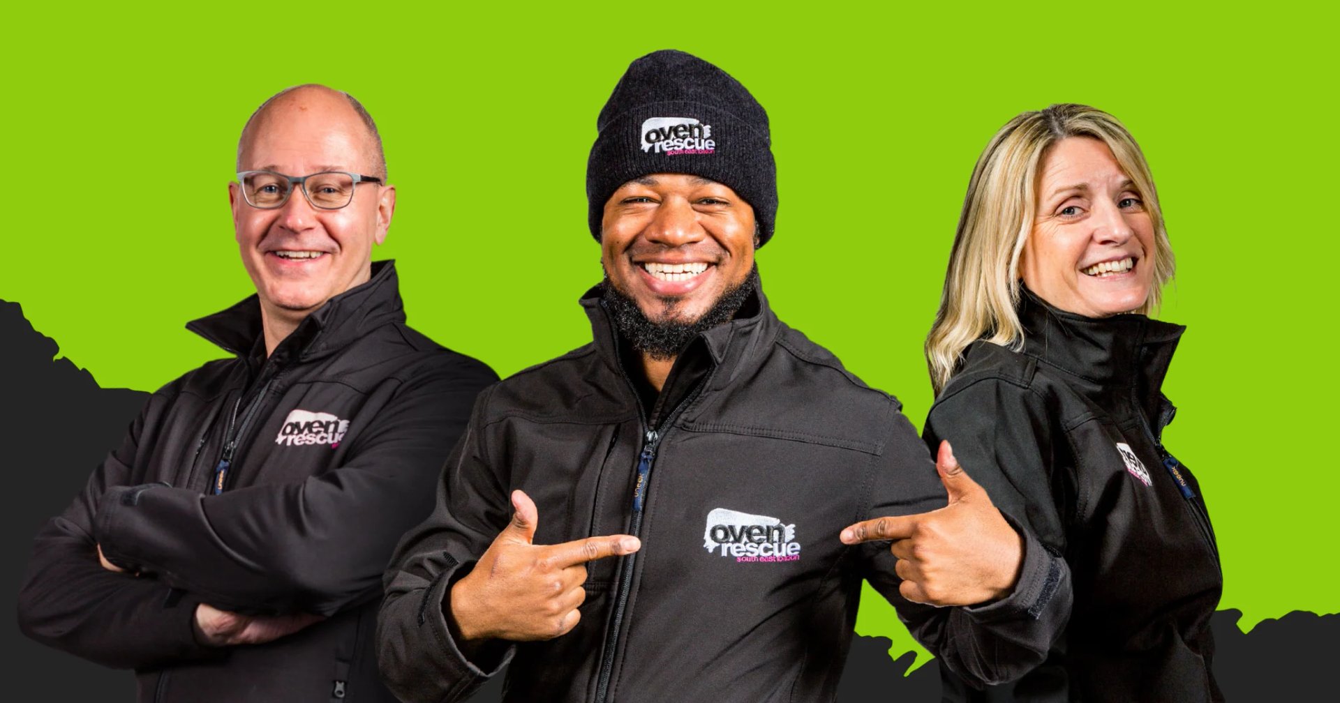 Three Oven Rescue team members in branded jackets posing against a green background, one pointing to the logo on his jacket