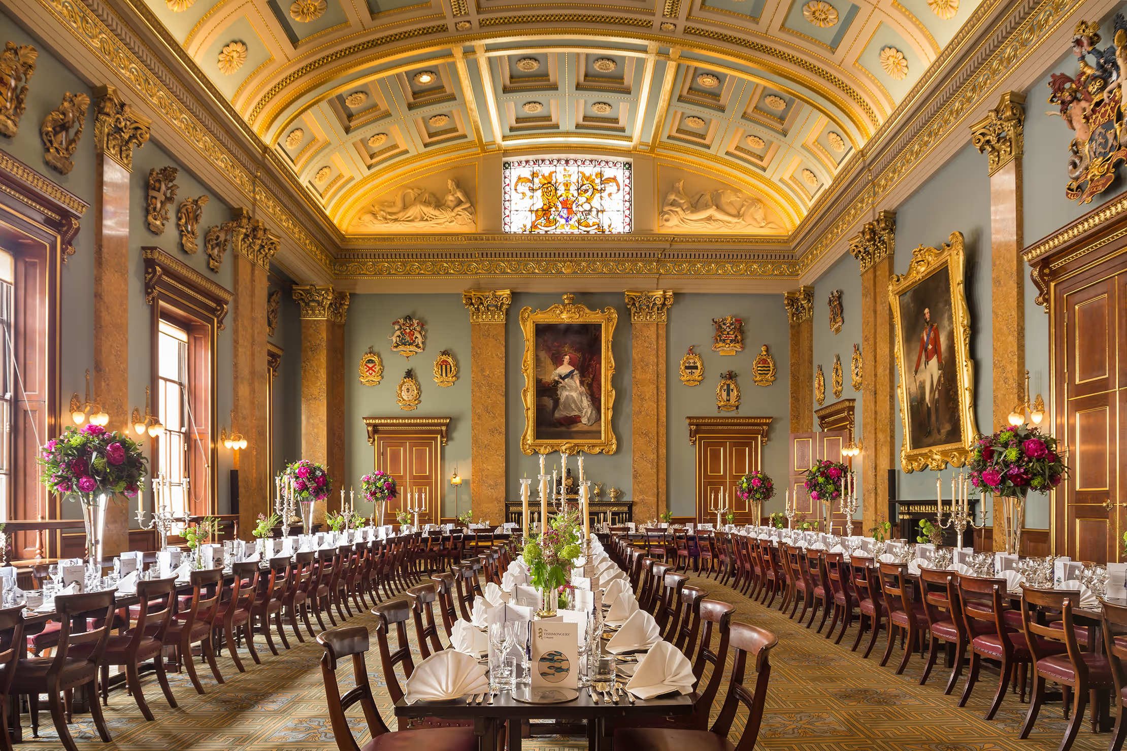 A shot of the regal Fishmongers Hall, three rows of neat tables in a large dining hall