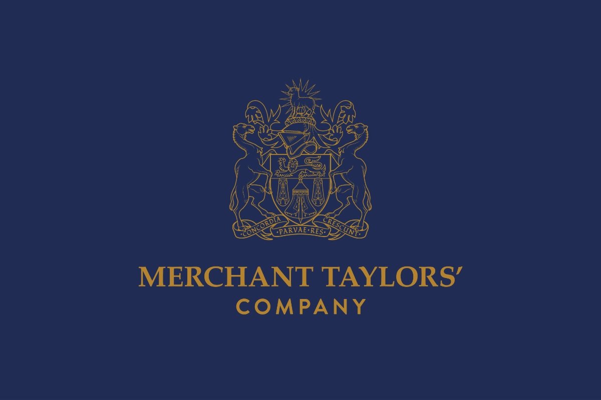The Merchant Taylors logo in golden yellow on a dark blue background.