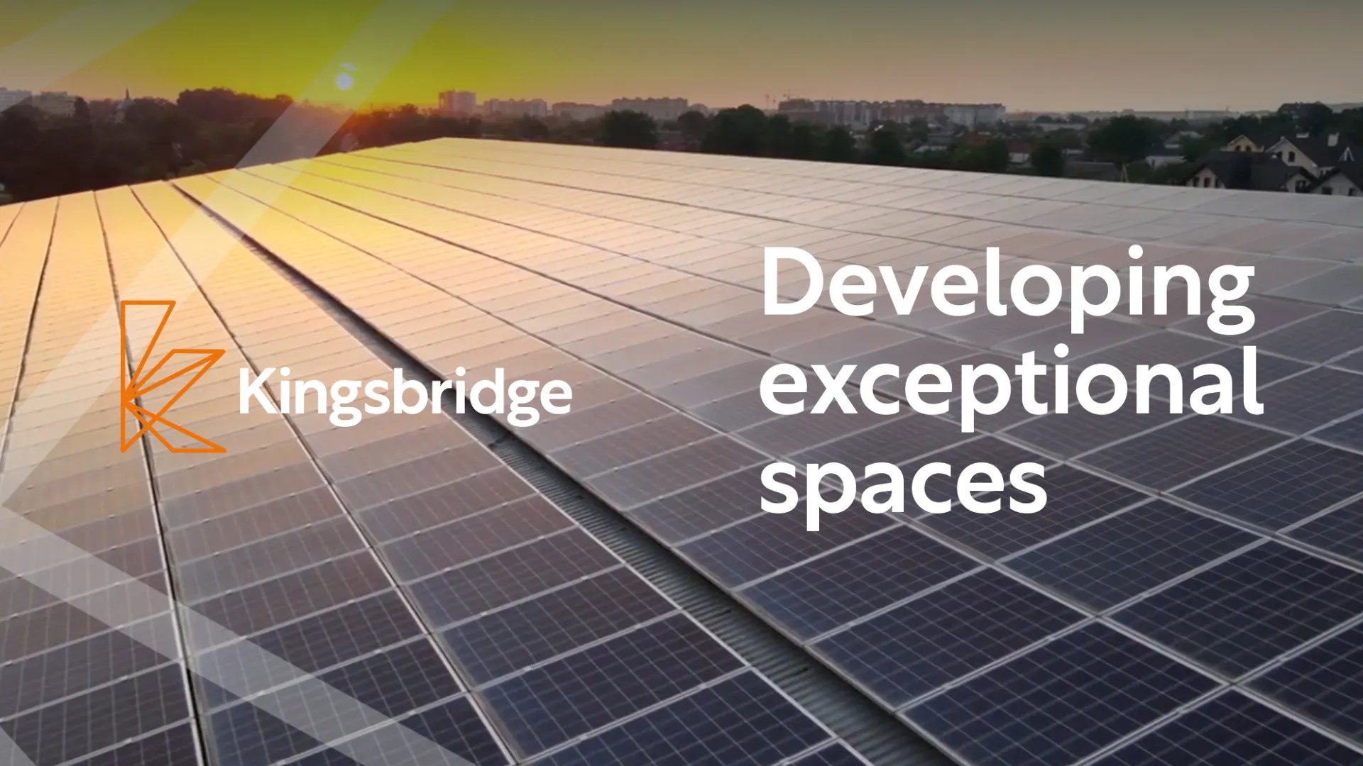A slide featuring the Kingsbridge logo, with the text 'Developing exceptional spaces' with a background of solar panels on a roof at sunset
