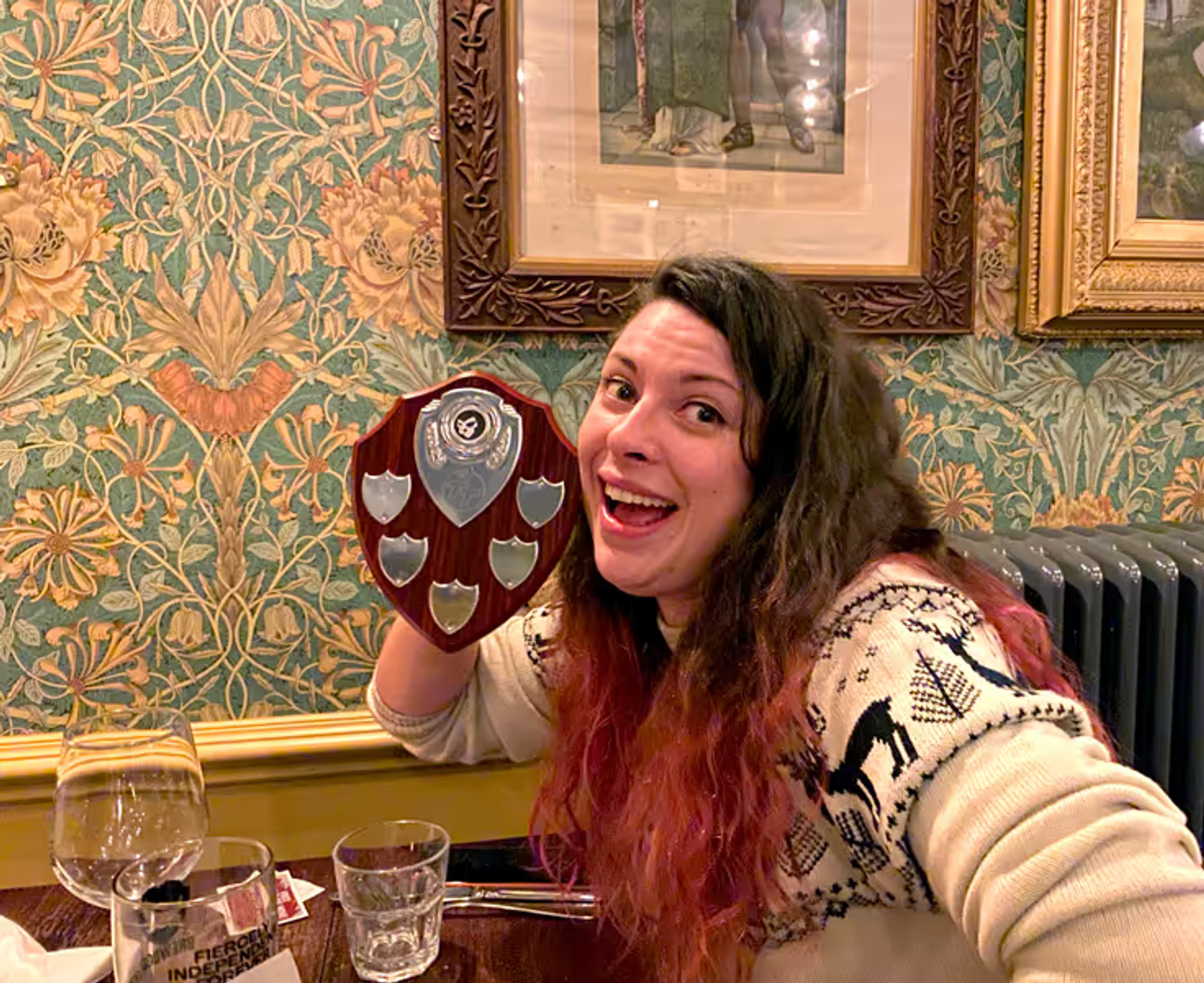 A young woman holding up a plaque