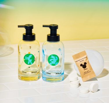 Donald & Daisy Hand Soap Duo: 2 forever bottles next to 6 refill tablets on white tiled surface with bubble