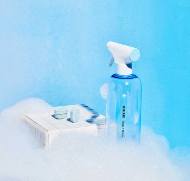 Blueland Glass + Mirror Starter Set: 1 refillable cleaning bottle 3 tablets in foam with blue background