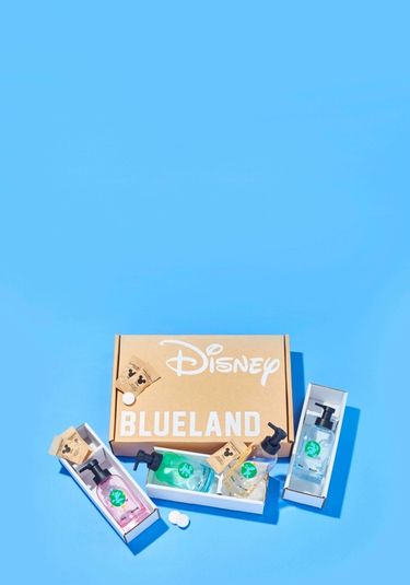Disney & Blueland 4 piece hand soap set: 4 classic Disney characters on colored bottles on blue surface