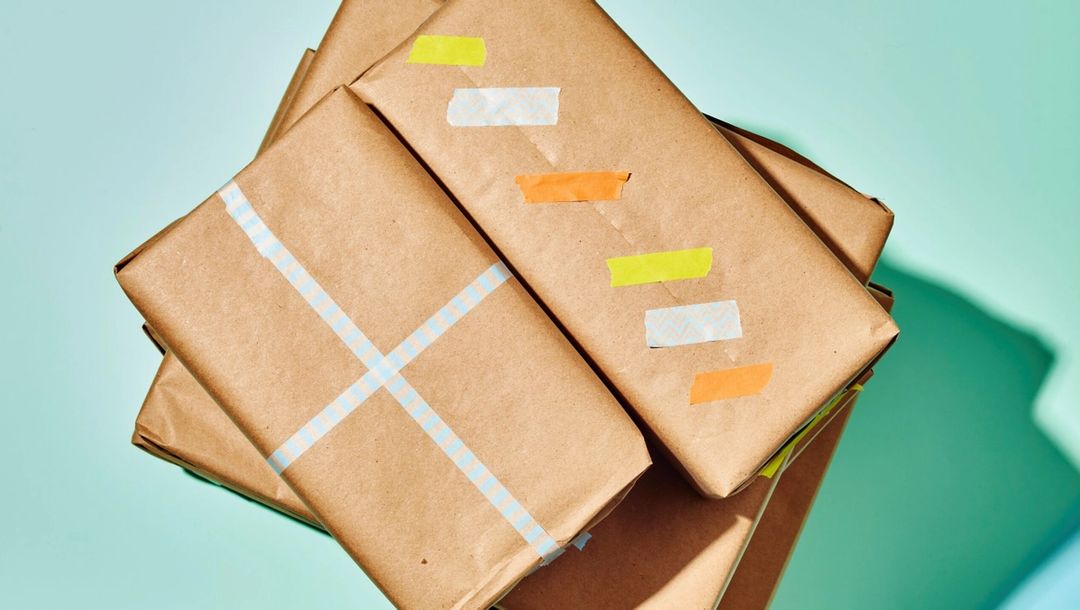 Wrapped packages in brown paper packaging with colorful paper tape