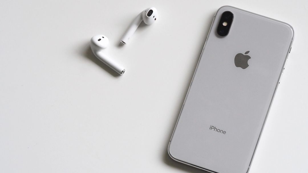 Apple iphone and apple airpods on white background