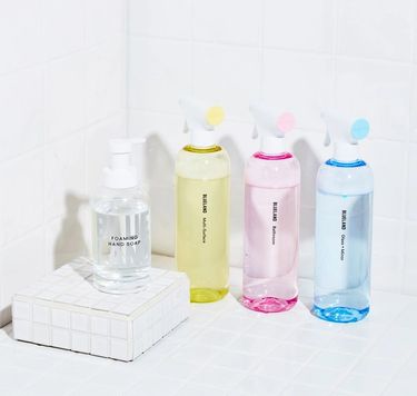 Clean Essentials Kit on white tile: 3 refillable cleaning bottles and tablets, 1 refillable Hand Soap bottle and tablet