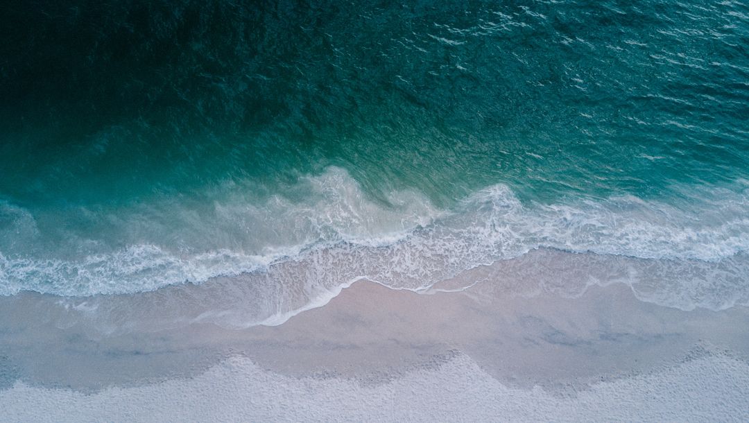 Ocean waves against empty beach