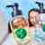 Mother and daughter look up behind Donald & Daisy hand soap duo bottles