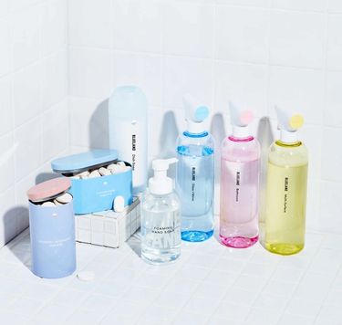 3 refillable cleaning bottles, Foaming Hand Soap, laundry tablets, dishwasher tablets, Powder Dish Soap on white tile