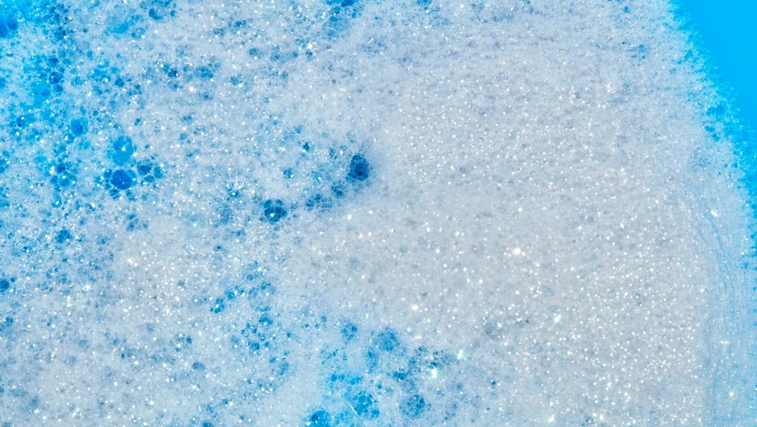soap suds against bright blue background