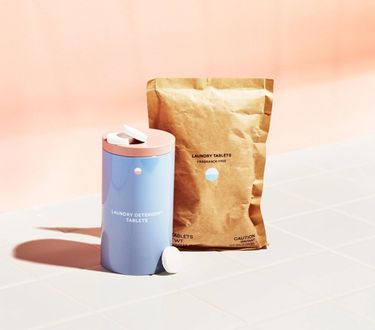 Laundry Starter Set: 1 Forever tin and compostable refill pouch on tile with  pink background