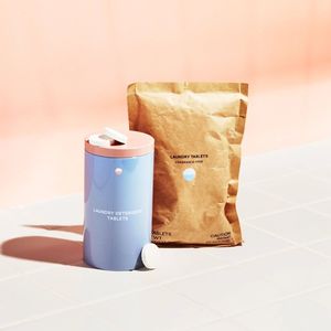 Laundry Starter Set: 1 Forever tin and compostable refill pouch on tile with  pink background