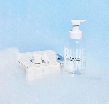 Blueland Hand Soap against white and blue tile: 1 refillable glass  bottles, 3 Foaming Hand Soap Tablets