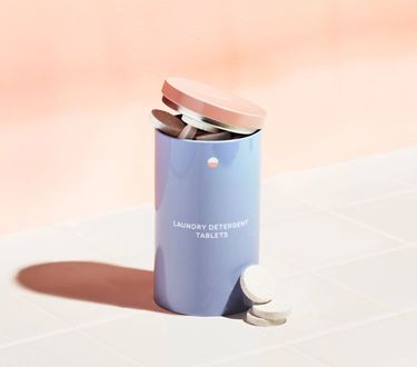 Laundry Starter Set: 1 Forever tin with naked laundry tablets inside on white tile with pink background