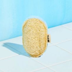 1 Scrub Sponge with yellow loofah side on blue sponge on white tile with blue background