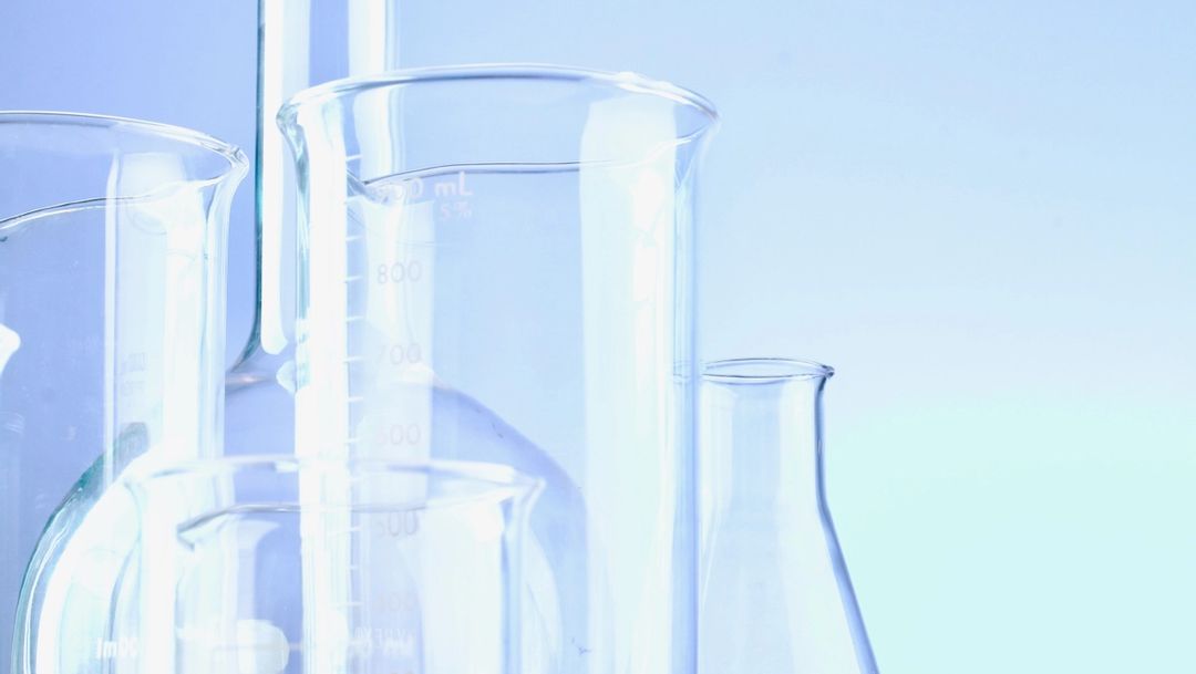 Empty chemistry bottles against blue background