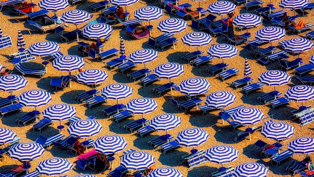 Blue and white umbrellas on a beach