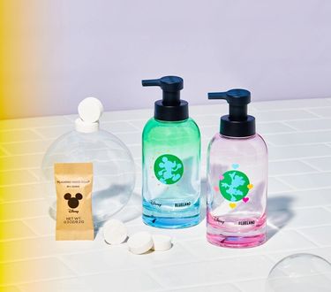 Mickey & Minnie Hand Soap Duo: 2 forever bottles next to 6 refill tablets on white tiled surface with bubble