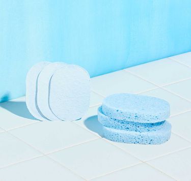 6 blue Pop-Up Sponges against white tile on blue background