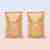 2 pouches of Oxi Laundry Booster powder in compostable packaging against peach background