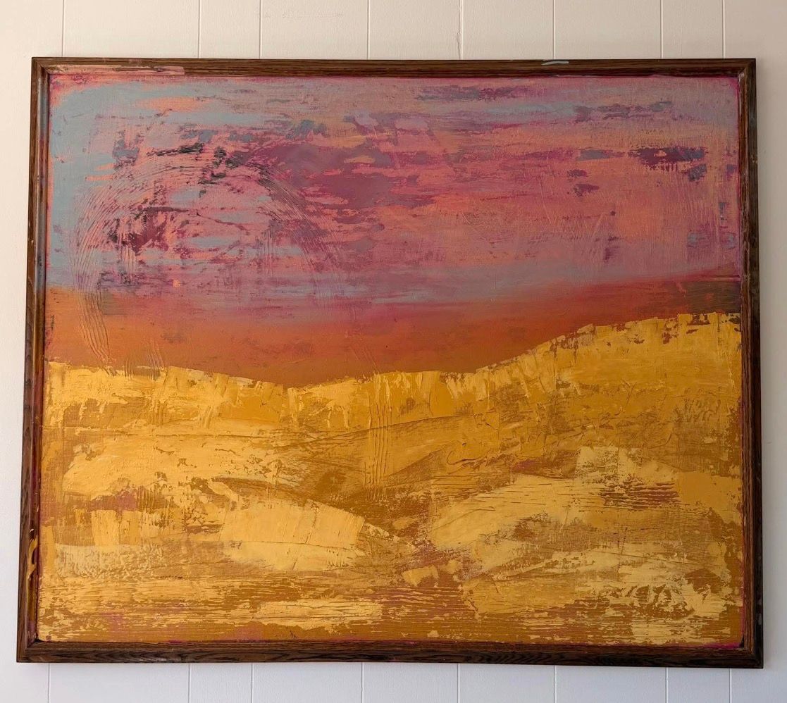 Abstract painting of gold hills with pink sunset on white wall