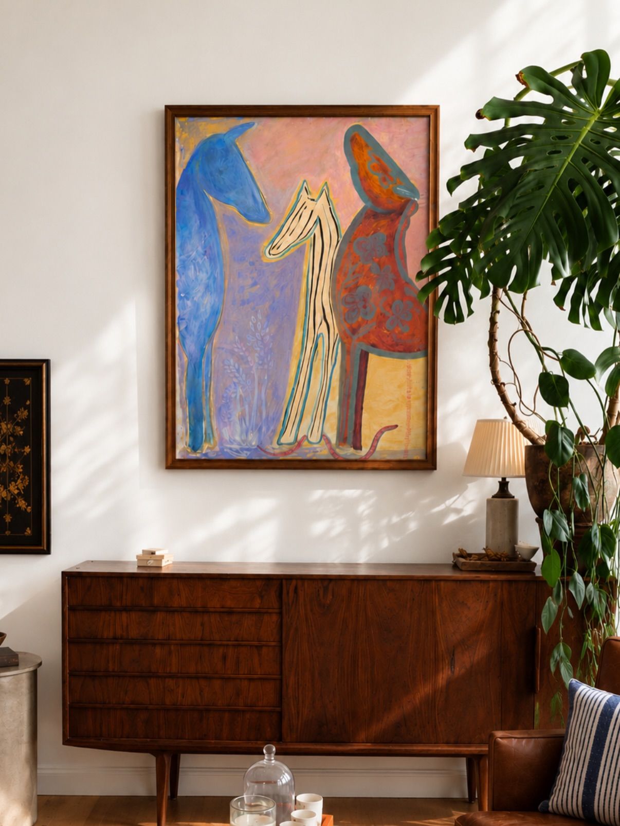 Three Graces hung above a mid-century credenza in a living room